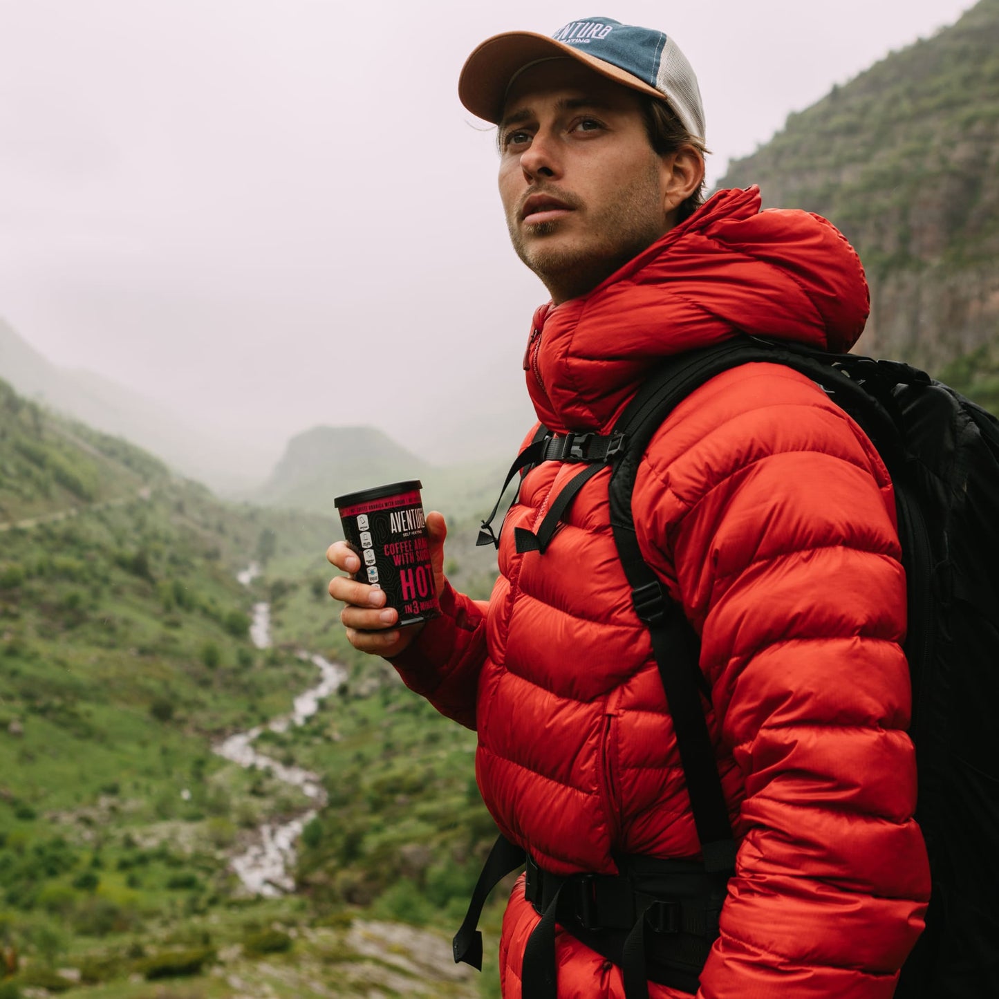Aventura Self Heating Chocolate Drink Hot in 3 minutes being held by a person hiking in mountains.
