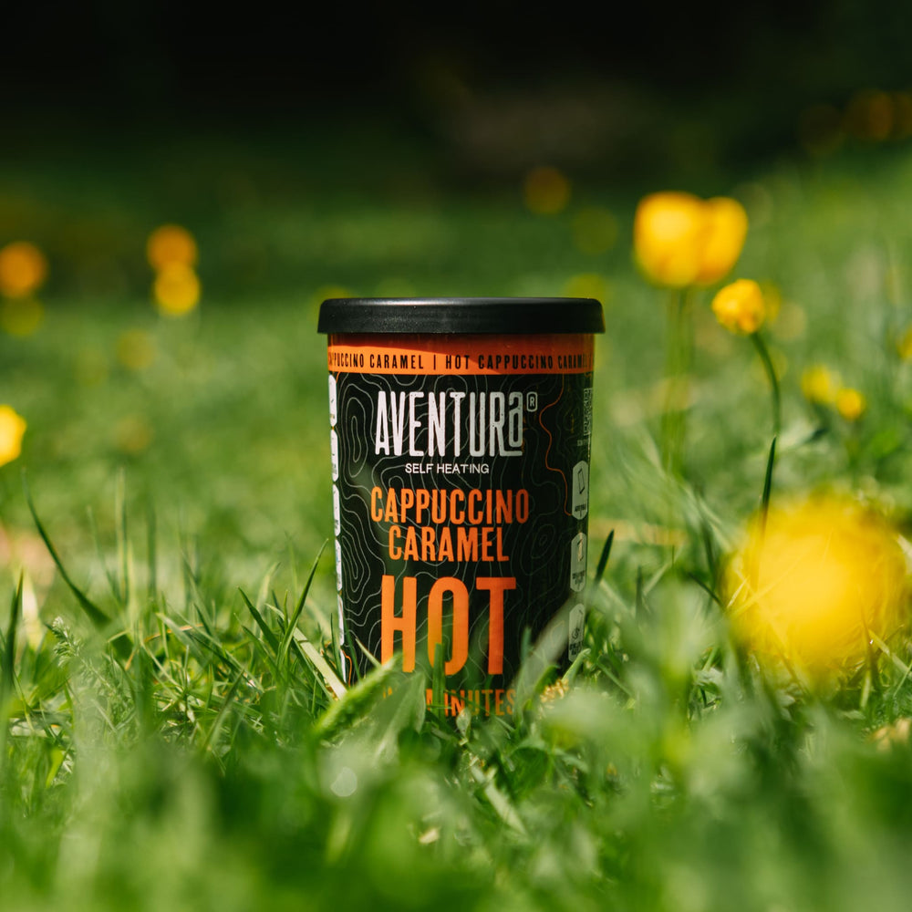 
                  
                    Aventura Self Heating Cappuccino Caramel in 3 minutes place in a field with yellow flowers around it
                  
                