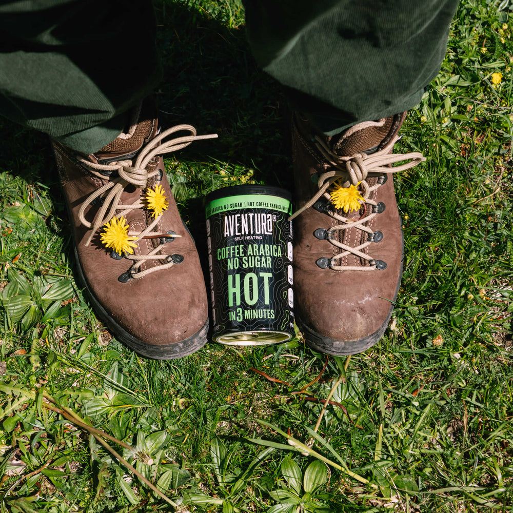 
                  
                    Aventura Self Heating Coffee Arabica No Sugar Hot in 3 Minutes between camping shoes or hiking shoes on grass.
                  
                
